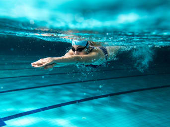 Swimming - Swimmer dives into the water. Swimming - Swimmer dives into the water.