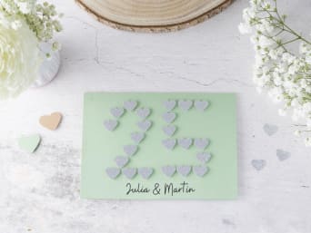 Silver wedding anniversary card: DIY greeting card with the number 25 made out of paper hearts. Silver wedding anniversary card: DIY greeting card with the number 25 made out of paper hearts.