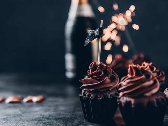 New Year’s Eve dessert - mini cupcakes with chocolate icing.  New Year’s Eve dessert - mini cupcakes with chocolate icing.
