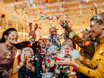 Things to do New Year’s Eve with kids: A family celebrates New Year’s Eve together by throwing confetti. Things to do New Year’s Eve with kids: A family celebrates New Year’s Eve together by throwing confetti.