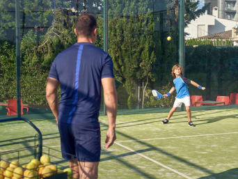 Padel-Tennis Anfänger: Ein kleiner Junge lernt in einer Trainingsstunde Padel-Tennis.  Padel-Tennis Anfänger: Ein kleiner Junge lernt in einer Trainingsstunde Padel-Tennis.