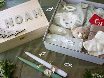 Presents for a christening: more ideas for baptism gifts laid out on a table.  Presents for a christening: more ideas for baptism gifts laid out on a table.