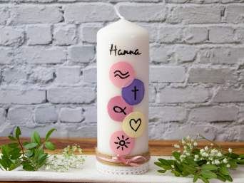 A christening candle with colourful patterns. A christening candle with colourful patterns.
