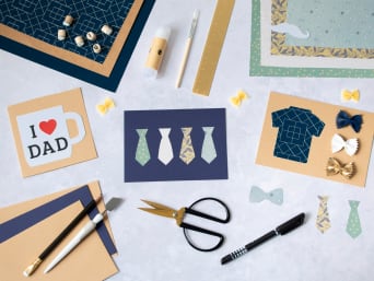 Making a Father's Day card: craft materials for Father's Day cards on a table.