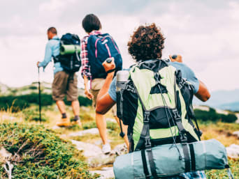 A hiking group walking along a rocky path. A hiking group walking along a rocky path.