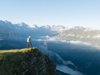 Long-distance hiking in Europe: a hiker enjoying a mountain view. Long-distance hiking in Europe: a hiker enjoying a mountain view.