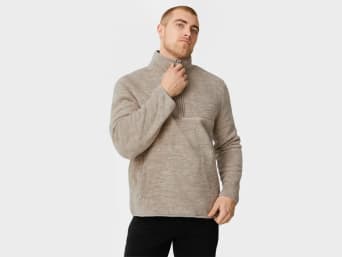 Fleece - a man zipping up his fleece.  Fleece - a man zipping up his fleece.