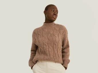 Wool - a woman wearing a knitted wool jumper. Wool - a woman wearing a knitted wool jumper.