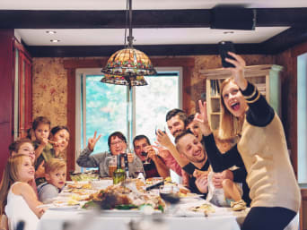 Creative Christmas family photos: a family taking a silly selfie at their dining table. Creative Christmas family photos: a family taking a silly selfie at their dining table.
