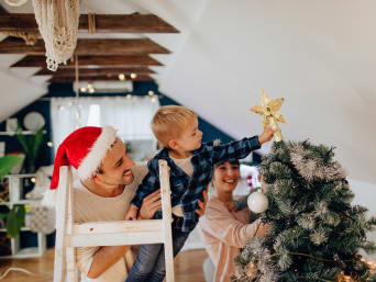 Christmas traditions: A family decorating the Christmas tree together. Christmas traditions: A family decorating the Christmas tree together.