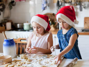 Easy biscuit recipe – two little girls cutting out shapes from dough using biscuit cutters.  Easy biscuit recipe – two little girls cutting out shapes from dough using biscuit cutters.