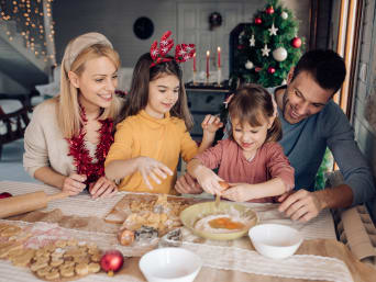 Easy Christmas biscuit recipes for children – a family making biscuits together. Easy Christmas biscuit recipes for children – a family making biscuits together.