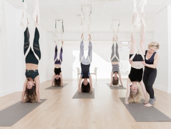 Aerial Yoga: A group of women doing aerial yoga. Aerial Yoga: A group of women doing aerial yoga.