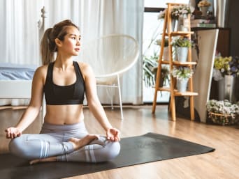 Yoga at home - woman practising at home on the yoga mat Yoga at home - woman practising at home on the yoga mat
