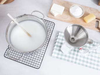 Homemade wool detergent: using a funnel to fill a bottle with the cooled laundry detergent. Homemade wool detergent: using a funnel to fill a bottle with the cooled laundry detergent.
