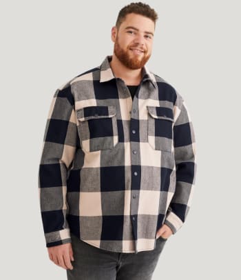 What is a relaxed fit? A man wearing a relaxed fit shirt.
