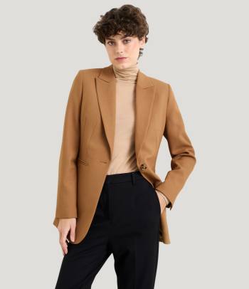A woman wearing a stylish smart-casual office party outfit.