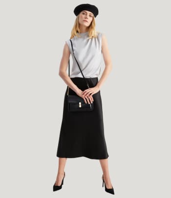 A woman wearing a chic smart-casual dress for an office party.