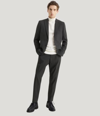 A man wearing a stylish business-casual office party outfit.