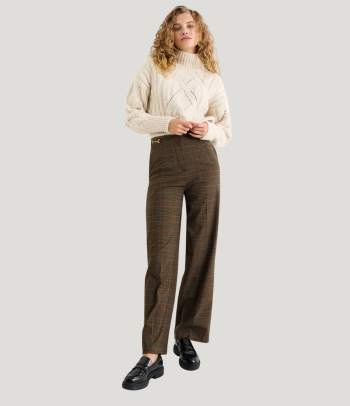A smart casual outfit for a Christmas party at work: a knitted jumper and elegant trousers.