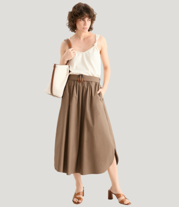 Christening outfits for women: a smart top paired with an elegant skirt.