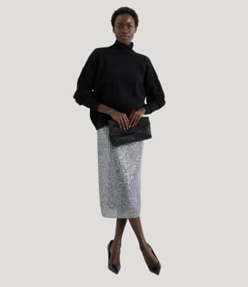 How to style a midi-skirt for a festive occasion: an outfit showing off a silver sequinned skirt.