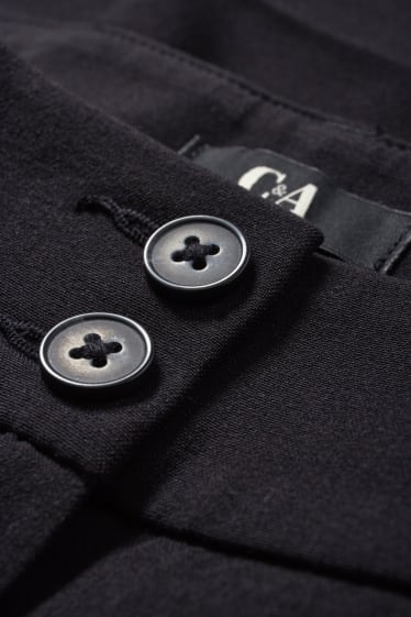 Dona - Pantalons de tela - mid waist - flared fit - negre