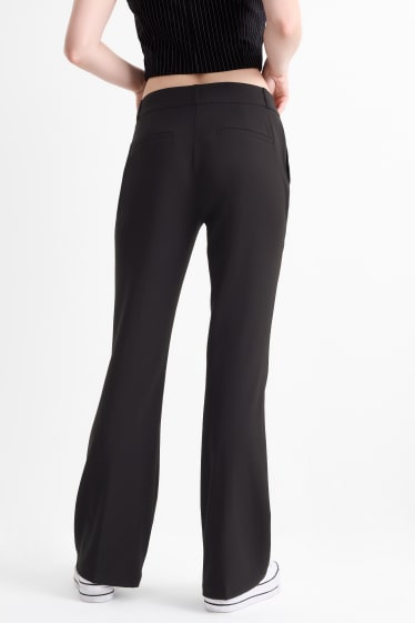 Dona - Pantalons de tela - mid waist - flared fit - negre