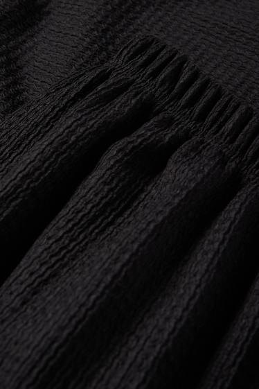 Dona - Pantalons de punt - mid waist - wide leg - texturats - negre