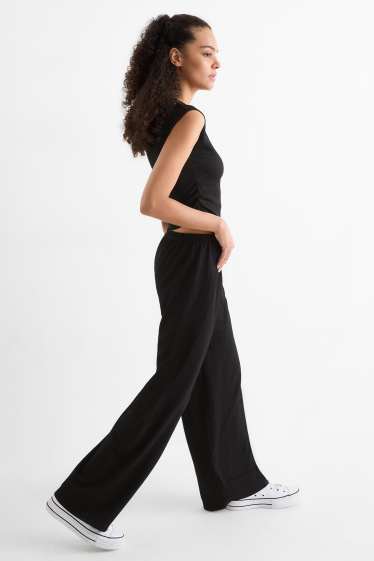 Dona - Pantalons de punt - mid waist - wide leg - texturats - negre