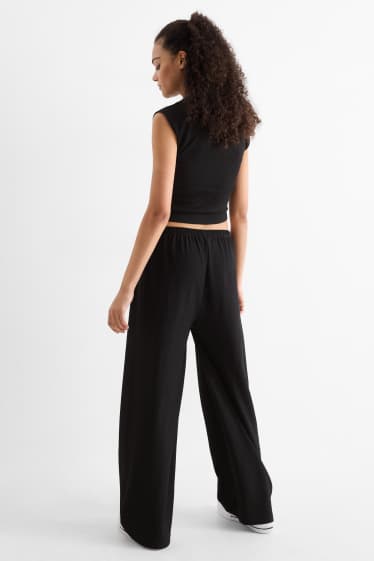 Dona - Pantalons de punt - mid waist - wide leg - texturats - negre