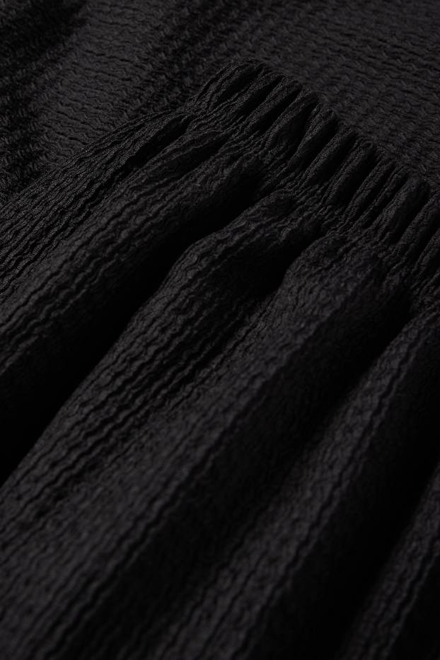Dona - Pantalons de punt - mid waist - wide leg - texturats - negre