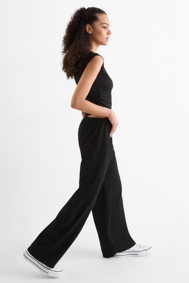 Dona - Pantalons de punt - mid waist - wide leg - texturats - negre