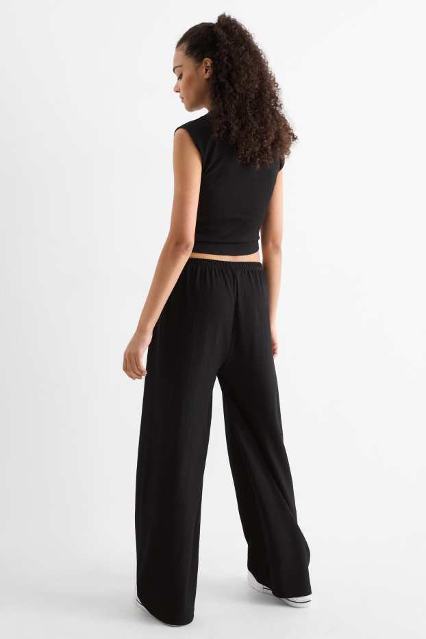 Dona - Pantalons de punt - mid waist - wide leg - texturats - negre
