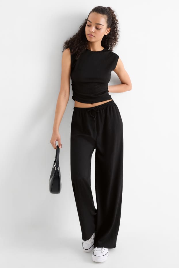 Dona - Pantalons de punt - mid waist - wide leg - texturats - negre